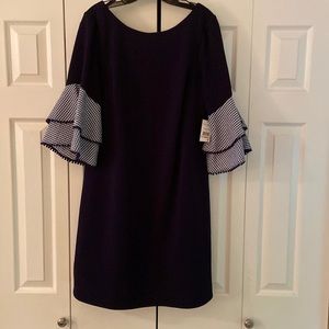 Jessica Howard navy shift style dress with navy/white checked bell sleeves.